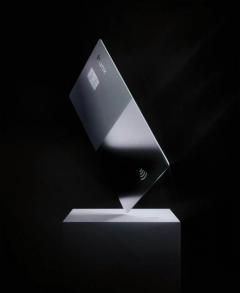 A laptop half-closed on a dark surface in low light