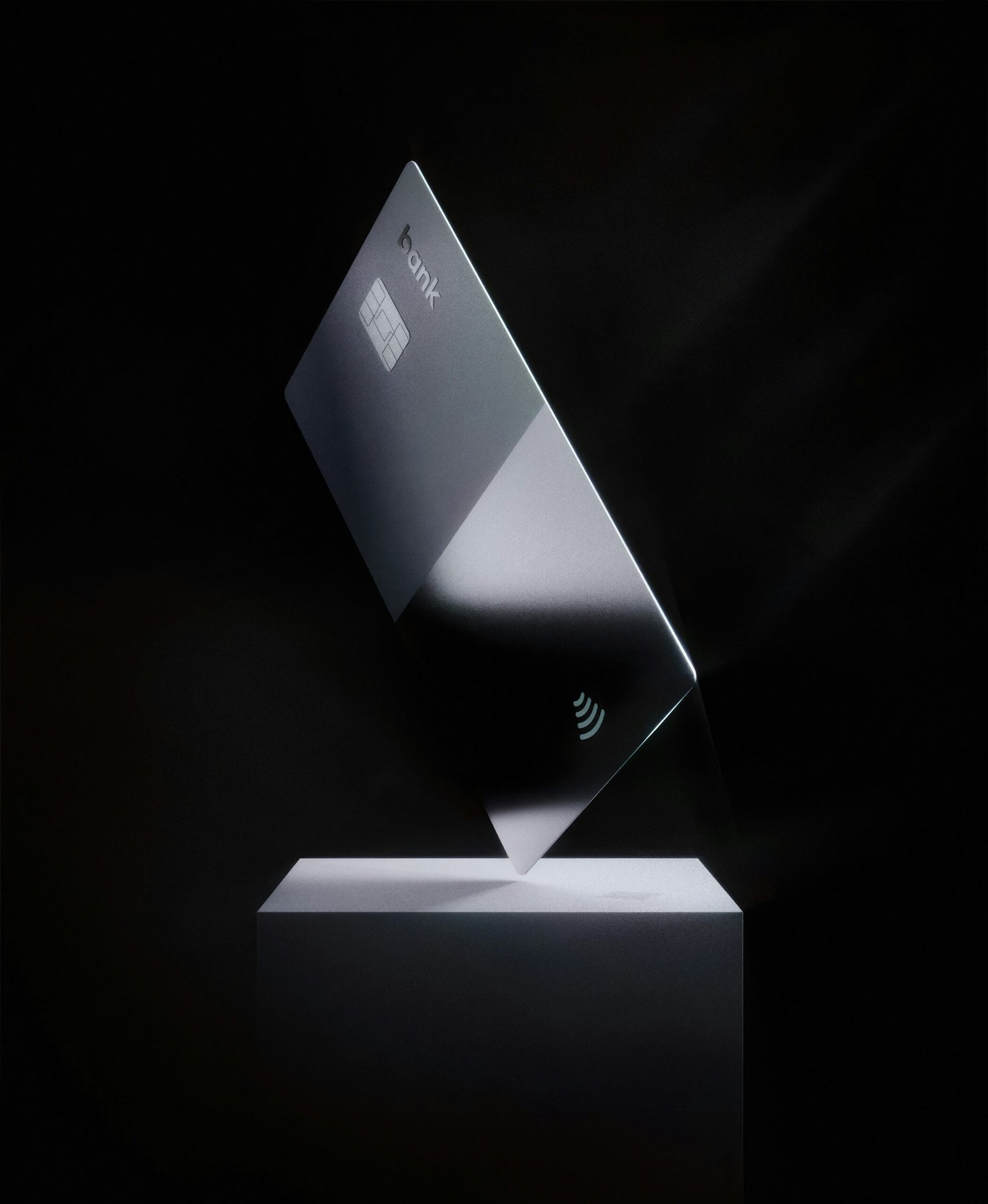 A laptop half-closed on a dark surface in low light