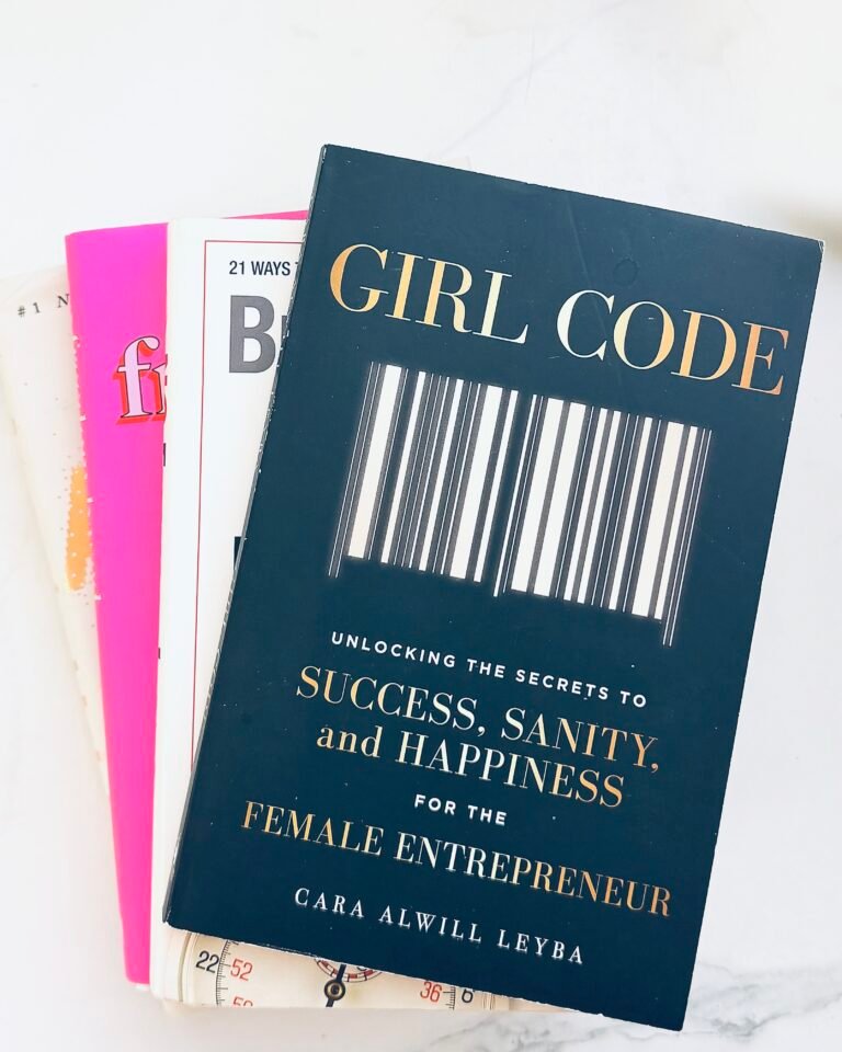 The book Girl Code propped against a pink background