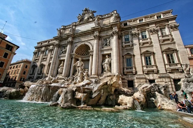 The Trevi Fountain in Rome against a bright blue sky