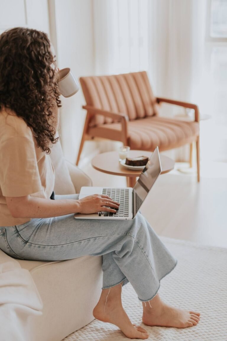 woman working on laptop in cozy living room