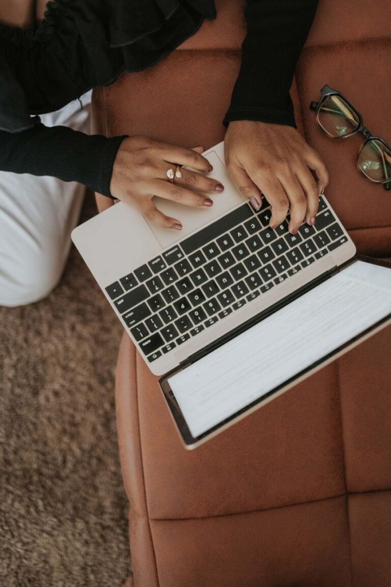 woman typing on laptop in cozy home setting