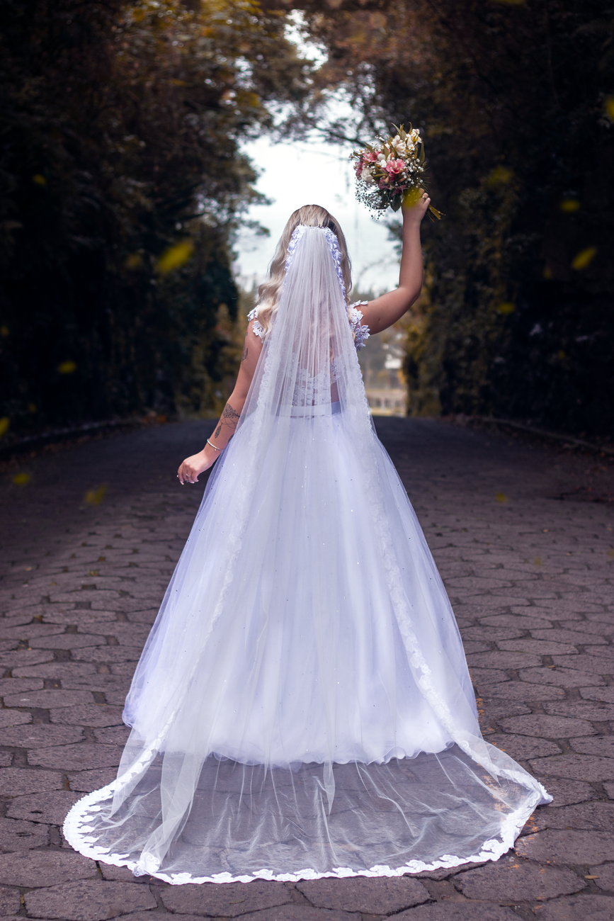 back view of a bride holding up a bouquet of flower